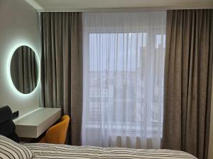 a hotel room with a bed and a window at ZEN home in Chişinău