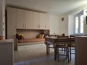 a living room with a couch and a table at La Casa Del Borgo in Torre Pellice +13 photos