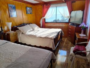 Ένα ή περισσότερα κρεβάτια σε δωμάτιο στο Hostal Casa Patrimonio Valparaíso