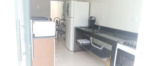 a kitchen with a refrigerator and a sink and a counter at Casa Sol in Prado +1 photo