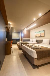 a hotel room with two beds in a room at Easy Porto Hotel in Porto De Galinhas