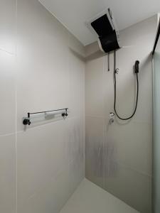 a bathroom with a shower with a glass door at Studio Elegante Próxi a USP By Marcolini in Sao Paulo +31 photos