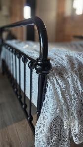 a black bed with a white lace dress on it at Lodge Klein Ganseij in Olst