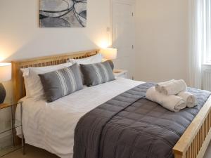 a bedroom with a large bed with two towels on it at Seaglass in Marazion