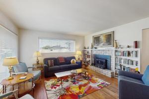 a living room with a couch and a fireplace at West End Wanderlust in Eureka