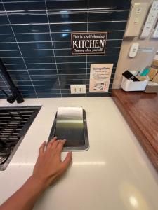 a person typing on a counter with a cell phone at The Bleu Mansion Iligan in Iligan +32 photos