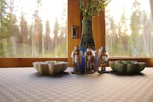 a table with two bowls and two figurines on it at Private Villa At Lake 