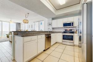 a kitchen with white cabinets and a large counter top at Summerwind West 0704 in Navarre