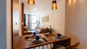 a dining room with a table with cups and saucers at Novíssimo! Na 2ª quadra do mar! in Vila Velha