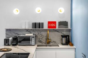 a kitchen with a counter top with a microwave at Contemporary 2-Bedroom Escape in Notting Hill in London +42 photos