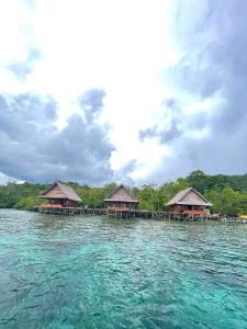 a group of bungalows on a island in the water at The Driftwood House 
