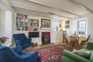 a living room with a fireplace and a table at The Nant in Haverfordwest