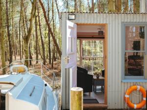 a tiny house with an open door and a porch at Chere Amie-Qu7616 in Melton Constable