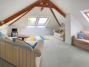 a living room with two couches and a table at The Bungalow in Saint Ishmaels