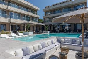 a swimming pool with lounge chairs and a hotel at Selena Beach Family Hotel - All Inclusive Light in Sozopol