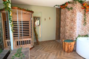 a bathroom with a stone wall and a toilet in a room at B&B Borgo Sciugolo in Baselice