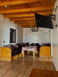 a living room with a black couch and a table at beachfront house in Taghazout