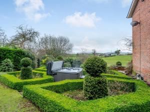a garden with a tv in the middle at Old Upper Gwestydd in Highgate