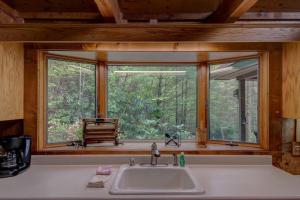 a kitchen with a sink and a large window at Hidden Creek Cabin in Fleetwood +88 photos