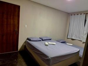 a bedroom with a bed with two towels on it at Casa Dona Flor in Morretes +35 photos