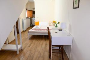 a room with a table and a bed and a desk at B&B Borgo Sciugolo in Baselice