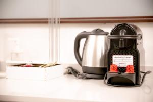 affeepot and a tea kettle on a counter at Spacious Loft in Rome Jewish Ghetto in Rome
