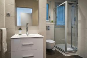 a bathroom with a toilet and a sink and a shower at Habitat Apartments Paseo de Gracia in Barcelona +18 photos