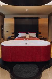 a bedroom with a large bed with a red and white bedvisor at Domaine des Terres du Val in Wanze