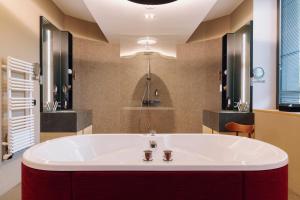 a bathroom with a large tub in a room at Domaine des Terres du Val in Wanze