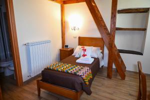 a small bedroom with a bed and a ladder at B&B Borgo Sciugolo in Baselice +39 photos