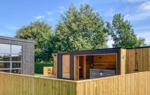 a wooden building on top of a fence at Awesome Home In Vinderup With Sauna in Vinderup +2 photos