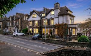 a large house on the side of a street at The Cranleigh Boutique in Bowness-on-Windermere