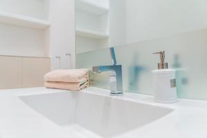 a bathroom with a sink and a towel and a mirror at Appartement Baltic Pearl in Ostseebad Sellin