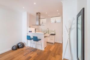 a kitchen with a counter and stools in a room at Appartement Baltic Pearl in Ostseebad Sellin