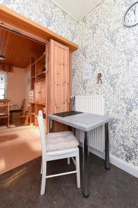 uma sala de jantar com uma mesa e uma cadeira em Ferienhaus Blauer Anker em Bensersiel mais 16 fotografias