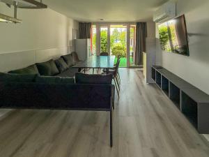 a living room with a couch and a table at Aranypart Camping & Apartments in Siófok