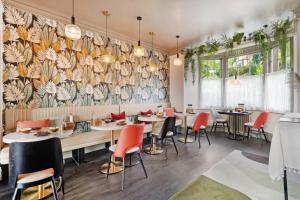 a dining room with tables and chairs and a mural at The Cranleigh Boutique in Bowness-on-Windermere