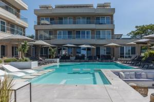 a swimming pool in front of a building at Selena Beach Family Hotel - All Inclusive Light in Sozopol