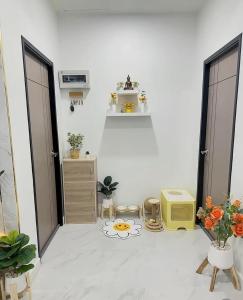 a white living room with a room with a tv at Peace Transit Hotel in Dar es Salaam