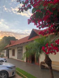 a building with a tree with pink flowers at Estância Hotel in Jardim +37 photos