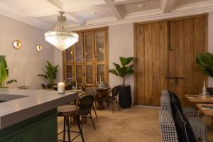a dining room with tables and chairs and a chandelier at Hotel Casa Bianca by Faranda Boutique in Cartagena de Indias +69 photos