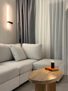 a living room with a couch and a candle on a table at Nexa Suite in Komotini