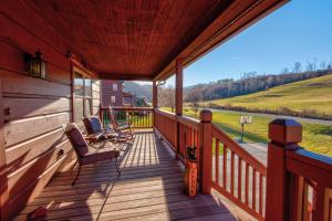 a porch of a cabin with a chair and a view at New River Ramble in Todd