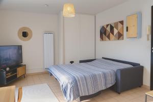 En eller flere senge i et værelse på Studio Jean Moulin