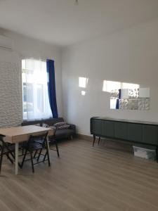 a living room with a table and a couch at Da zia Fabri in Gorizia