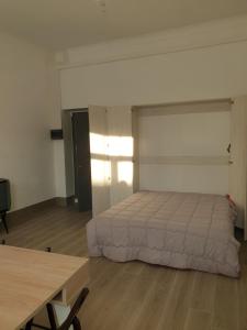 a bedroom with a bed and a table in it at Da zia Fabri in Gorizia