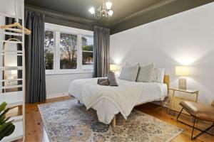 a bedroom with a bed and a window at Bedford Beauty Stylish Retro Family Home with office in Marion