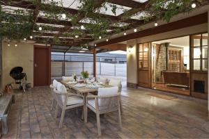 a dining room with a table and white chairs at Bedford Beauty Stylish Retro Family Home with office in Marion