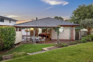 a backyard with a gazebo and a table at Bedford Beauty Stylish Retro Family Home with office in Marion