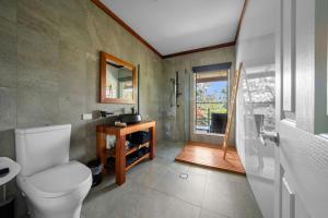 a bathroom with a toilet and a sink and a window at Zen-Inspired Hinoki Bath, Tatami and Washitsu Room in Eagle Heights +38 photos